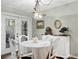 Quaint dining area with white table and chairs near French doors at 4253 Golf Club Ln, Tampa, FL 33618