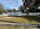 Backyard view showing a white brick house and a large grassy area at 4511 N Troy St, Tampa, FL 33610