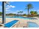 Relaxing pool area with lounge chairs and palm trees at 5843 Justicia Loop, Land O Lakes, FL 34639