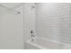 Clean bathroom with white subway tile and bathtub at 6667 Depue Dr, Wesley Chapel, FL 33545