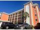 Orange building exterior with balconies and palm trees at 6960 20Th N Ave # 501, St Petersburg, FL 33710