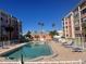Community pool with lounge chairs and palm trees at 6960 20Th N Ave # 501, St Petersburg, FL 33710