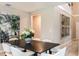 Elegant dining room with a dark wood table, white chairs, and wall art at 7679 Peace Lily Ave, Wesley Chapel, FL 33545