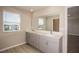 Modern bathroom with double vanity and large mirror at 7691 Peace Lily Ave, Wesley Chapel, FL 33545