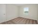 Bright bedroom with neutral walls, carpeted floors, and a window with blinds at 7703 Peace Lily Ave, Wesley Chapel, FL 33545