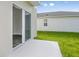 Private patio with sliding glass door access from the home at 7703 Peace Lily Ave, Wesley Chapel, FL 33545