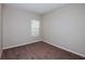 Spacious bedroom with neutral walls and brown carpet at 7735 Peace Lily Ave, Wesley Chapel, FL 33545