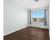 Well-lit bedroom with dark hardwood floors and window at 7860 Atwood Dr, Wesley Chapel, FL 33545