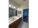Double vanity bathroom with a large mirror and access to the bedroom at 8216 Carriage Pointe Dr, Gibsonton, FL 33534