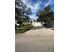 Single-story house with a white garage door and landscaped yard at 8216 Carriage Pointe Dr, Gibsonton, FL 33534