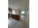 Kitchen with island, wood cabinets, and tile floor at 8216 Carriage Pointe Dr, Gibsonton, FL 33534