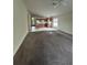 Spacious living room with carpet and kitchen view at 8216 Carriage Pointe Dr, Gibsonton, FL 33534