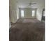 Large carpeted main bedroom with two windows at 8216 Carriage Pointe Dr, Gibsonton, FL 33534