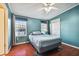 Bedroom with teal walls, wood floors, and a double bed at 8532 Fantasia Park Way, Riverview, FL 33578