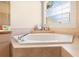 A bathroom with a large corner bathtub at 9272 Eldridge Rd, Spring Hill, FL 34608