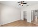 Bright bedroom featuring wood-look flooring, ceiling fan, and closet, creating a cozy and functional living space at 13213 106Th Ave, Largo, FL 33774