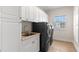 Laundry room featuring a sink, washer, dryer, and ample storage at 13213 106Th Ave, Largo, FL 33774