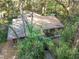 Aerial view of a rustic cabin nestled in the woods at 15577 Little Ranch Rd, Spring Hill, FL 34610