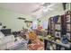 A cluttered bedroom with a bed and workspace at 15577 Little Ranch Rd, Spring Hill, FL 34610
