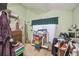 Small bedroom with dresser, desk, and window coverings at 15577 Little Ranch Rd, Spring Hill, FL 34610
