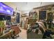 A cluttered bedroom with a TV and shelving unit at 15577 Little Ranch Rd, Spring Hill, FL 34610