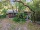 Rustic wooded cabin with walkway and landscaping at 15577 Little Ranch Rd, Spring Hill, FL 34610