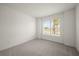 Simple bedroom with gray carpet and a large window at 17357 Comingo Ln, Punta Gorda, FL 33955