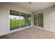 Covered patio with sliding glass doors and view of backyard at 17357 Comingo Ln, Punta Gorda, FL 33955