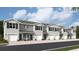 Exterior view of townhomes with attached garages and landscaping at 17440 Haysack Ter, Lakewood Ranch, FL 34211