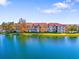 Luxury apartment buildings situated on a lake with lush green landscaping at 18106 Peregrines Perch Pl # 5204, Lutz, FL 33558