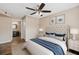 Comfortable bedroom with ceiling fan and ensuite bathroom access at 18106 Peregrines Perch Pl # 5204, Lutz, FL 33558