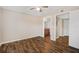 Bright bedroom with wood-look floors and access to bathroom at 18106 Peregrines Perch Pl # 5204, Lutz, FL 33558