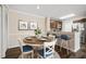 Bright dining area with a round table and four chairs, adjacent to kitchen at 18106 Peregrines Perch Pl # 5204, Lutz, FL 33558