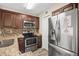 Updated kitchen boasting stainless steel appliances and wood cabinetry at 18106 Peregrines Perch Pl # 5204, Lutz, FL 33558