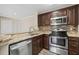 Modern kitchen featuring stainless steel appliances and granite countertops at 18106 Peregrines Perch Pl # 5204, Lutz, FL 33558