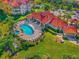 Community pool with plenty of lounge chairs and a spa at 18106 Peregrines Perch Pl # 5204, Lutz, FL 33558