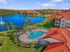 Resort-style pool and spa overlooking a tranquil lake at 18106 Peregrines Perch Pl # 5204, Lutz, FL 33558