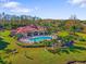 Community pool with surrounding lush landscaping at 18106 Peregrines Perch Pl # 5204, Lutz, FL 33558