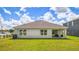 Rear view of house showcasing a backyard and patio at 18116 Canopy Pl, Bradenton, FL 34211