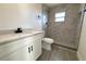 Modern bathroom with white vanity, marble shower, and grey tile flooring at 212 Francis Dr, Apollo Beach, FL 33572