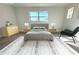 Cozy bedroom with large window, stylish furniture, and a neutral color palette creating a relaxing atmosphere at 212 Francis Dr, Apollo Beach, FL 33572