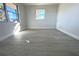 Bright bedroom with grey flooring and window at 212 Francis Dr, Apollo Beach, FL 33572
