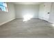 Bright bedroom with grey wood-look flooring at 212 Francis Dr, Apollo Beach, FL 33572