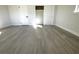 Spacious bedroom with grey wood-look flooring and ample closet space at 212 Francis Dr, Apollo Beach, FL 33572