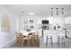 Bright, modern kitchen featuring white cabinetry, stainless steel appliances and an island with seating at 212 Francis Dr, Apollo Beach, FL 33572