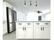 Kitchen island with white shaker cabinets and quartz countertop at 212 Francis Dr, Apollo Beach, FL 33572