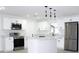 Modern kitchen with white cabinets, stainless steel appliances and an island at 212 Francis Dr, Apollo Beach, FL 33572