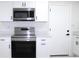 Modern kitchen with stainless steel Samsung range and microwave at 212 Francis Dr, Apollo Beach, FL 33572