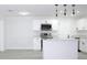 Modern kitchen with white cabinets, stainless steel appliances, and an island at 212 Francis Dr, Apollo Beach, FL 33572