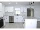 Modern kitchen with white cabinets, stainless steel appliances, and an island at 212 Francis Dr, Apollo Beach, FL 33572